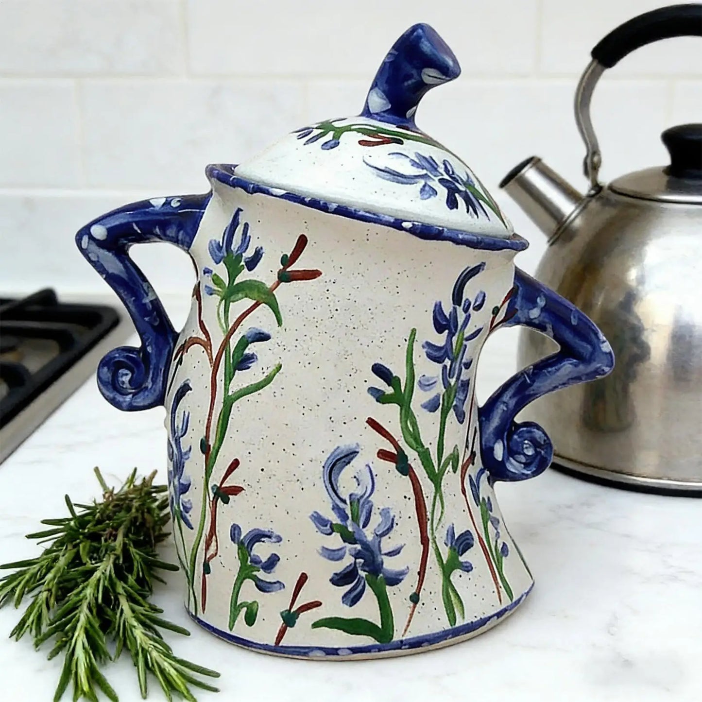 decorative ceramic storage jar with lid and speckled design on table