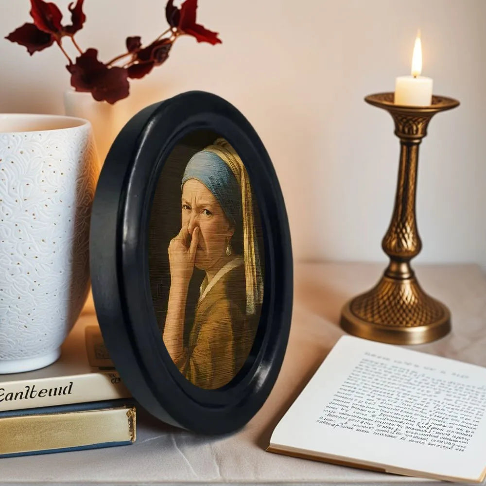 Small framed parody artwork featuring a humorous expression in a black oval frame, designed as quirky bathroom and home wall décor.