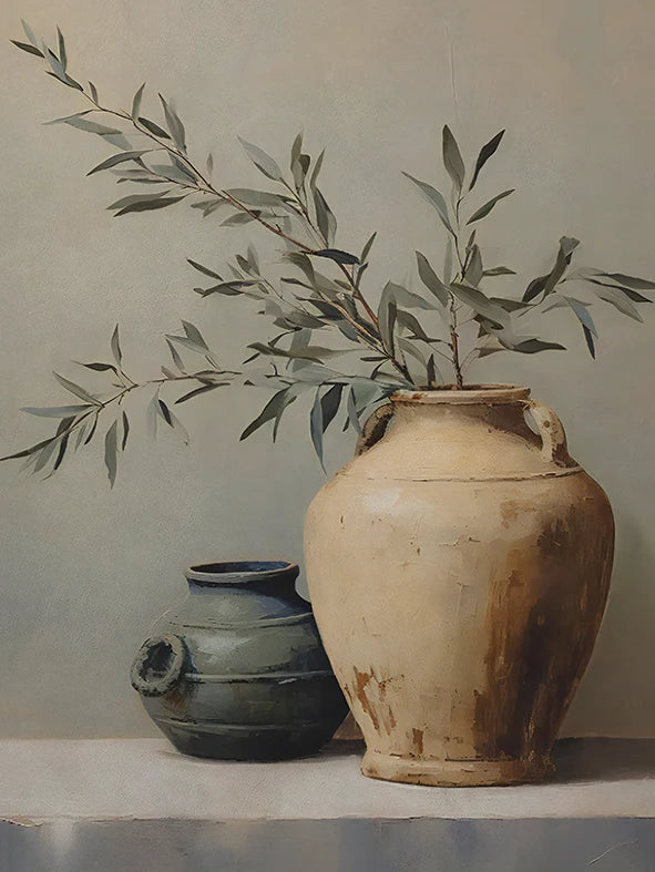 Two ceramic pots with a branch of leaves on a neutral background