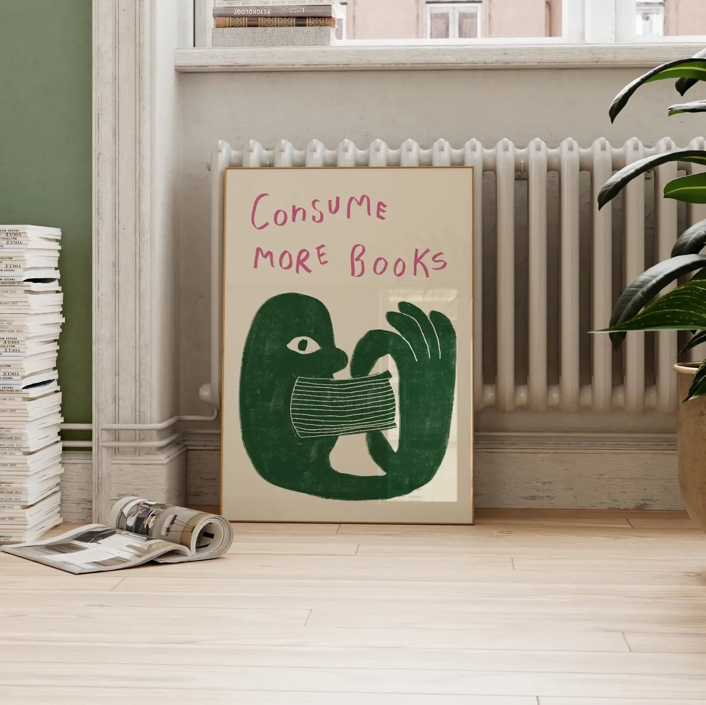 Poster with 'Consume More Books' text and green illustration of a hand holding a book in a room with books and a radiator.