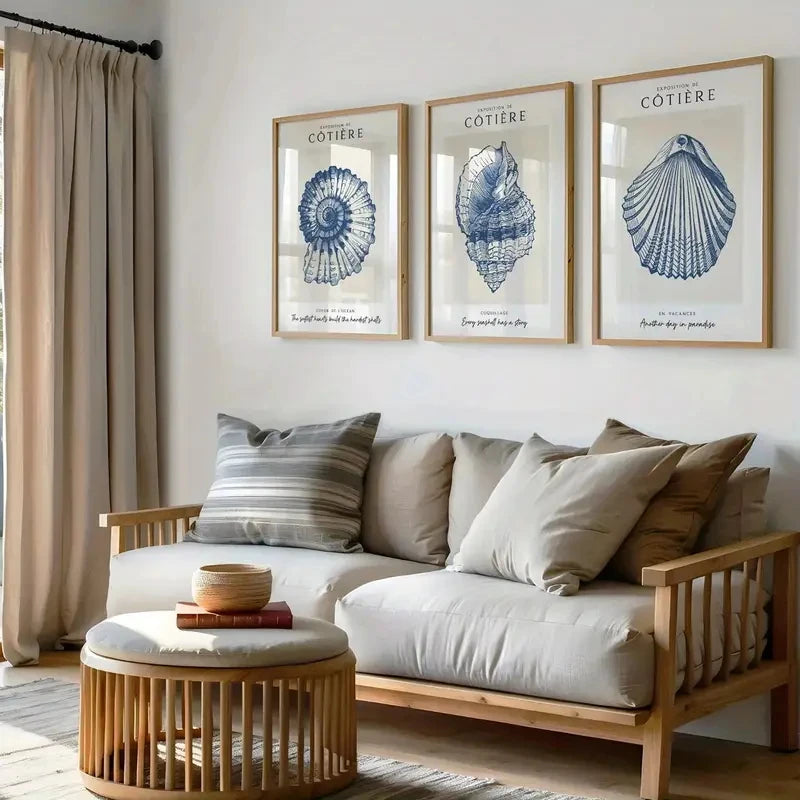 Living room with a sofa, coffee table, and wall art featuring shell designs.