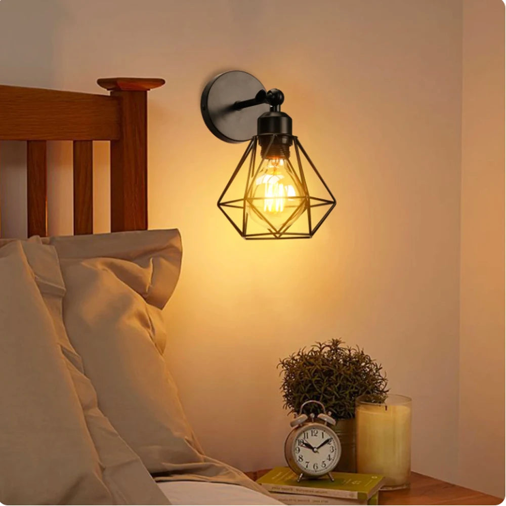 Wall-mounted lamp with geometric design on a bedside table next to a bed.