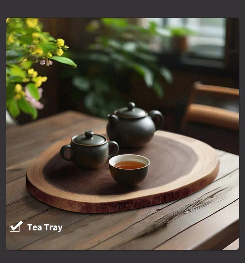 Tea set on a wooden tray with a blurred background of plants