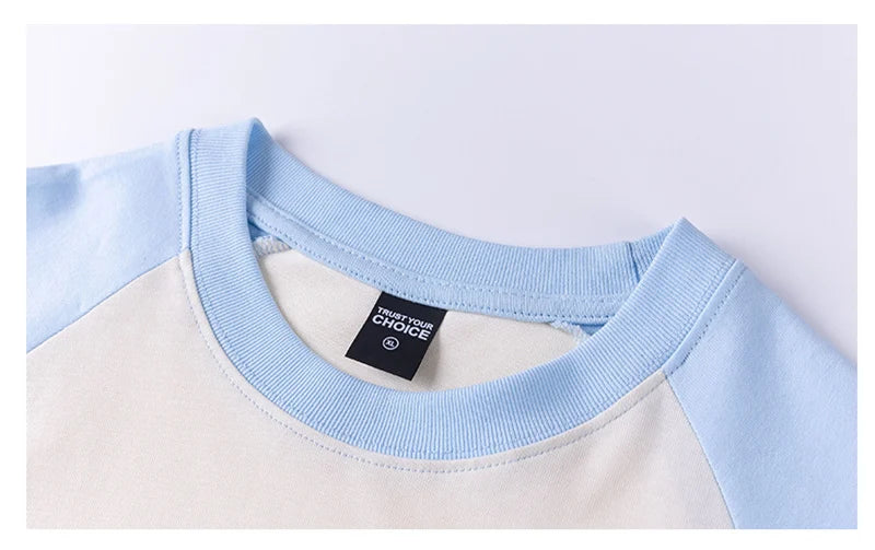 Close-up of a light blue and white shirt collar with a brand tag.