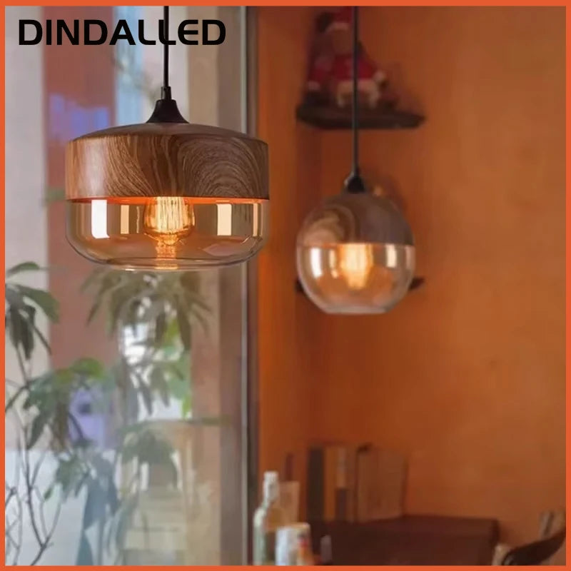 Wooden pendant light fixture in a room with an orange wall and plants.