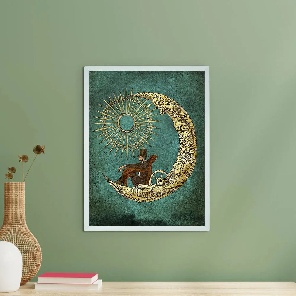 Framed artwork of a man on a crescent moon with sun and star designs against a green wall.