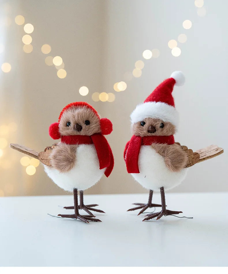 Two decorative birds wearing Santa hats and scarves against a blurred light background