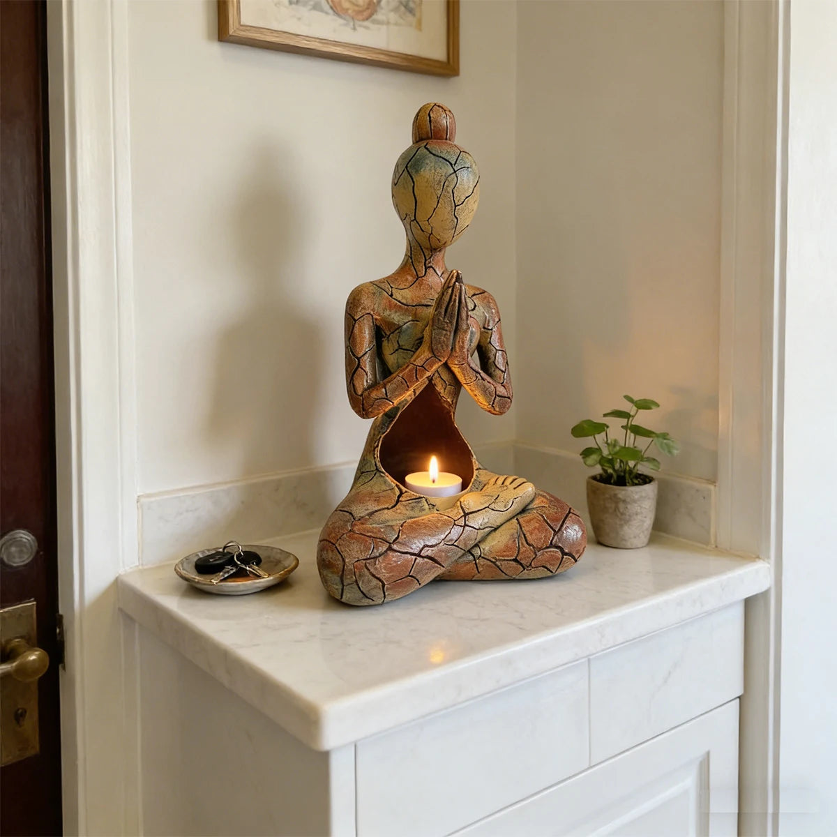 Artistic resin meditating figure ornament with a warm cracked-effect finish and hollow centre designed for a flameless LED candle.
