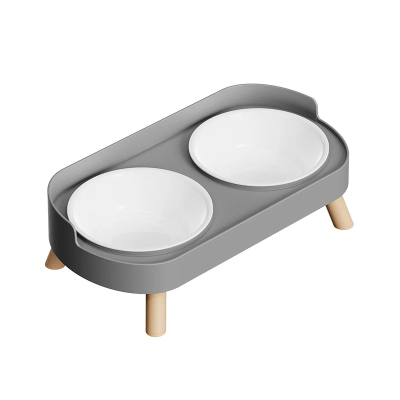 Gray pet feeder with two white bowls on a white background
