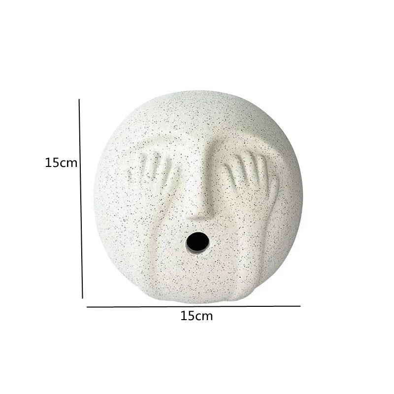 White ceramic face-shaped object with dimensions indicated on a white background