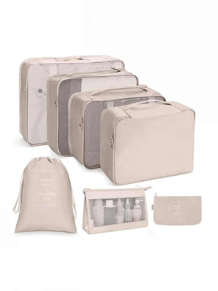 Set of beige and gray packing cubes on a white background