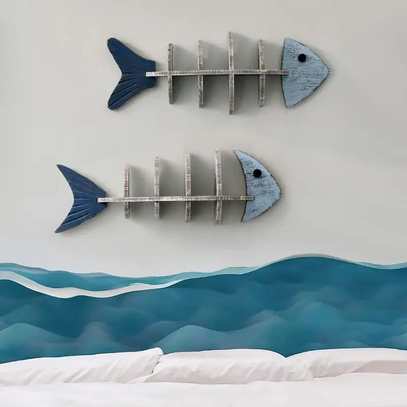 Two fish-shaped wall shelves with decorative items on a light gray wall.