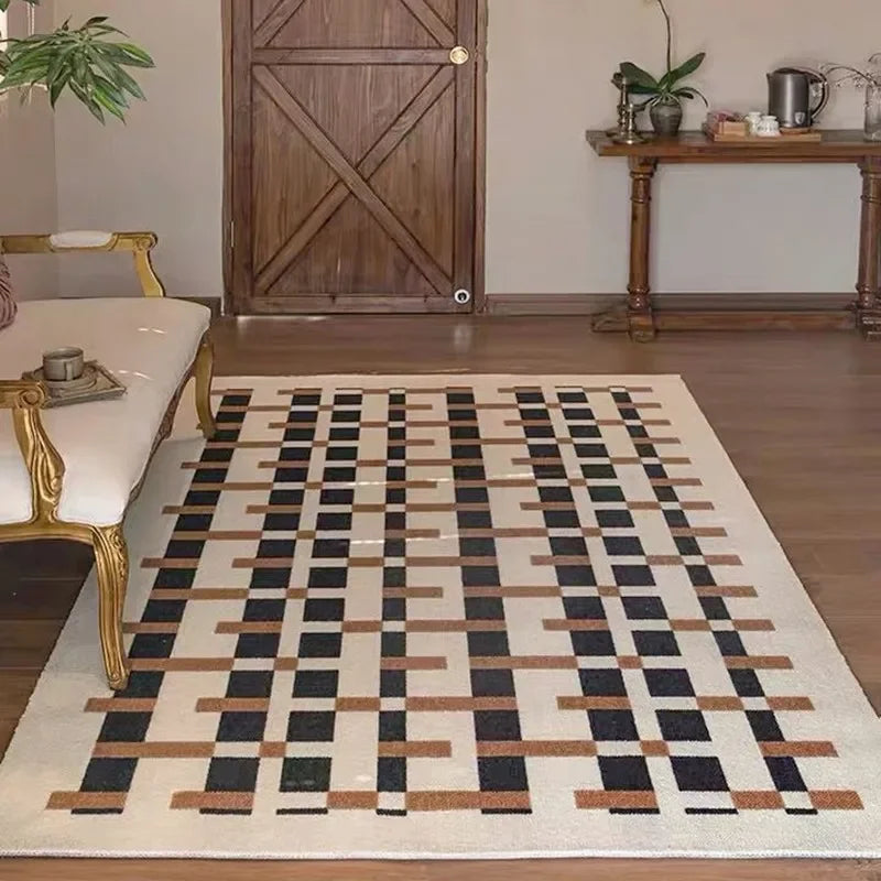 Patterned rug on a wooden floor with a couch and table in the background