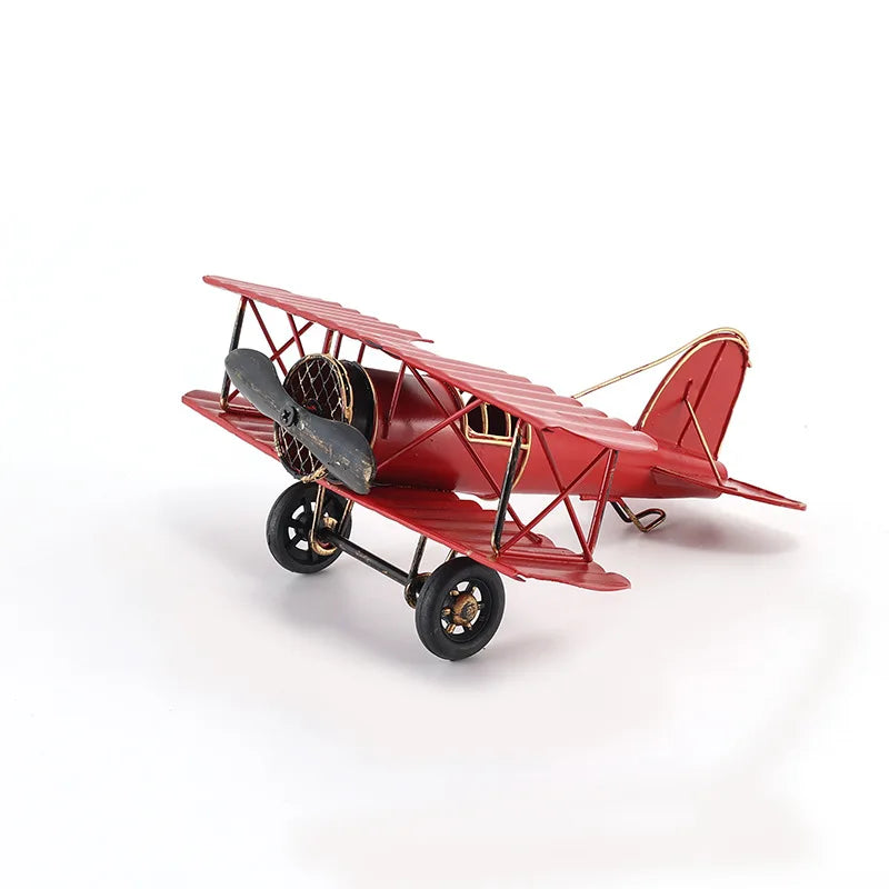Vintage metal airplane ornament with a detailed retro aircraft design, available in red, yellow and blue for desk or shelf display.