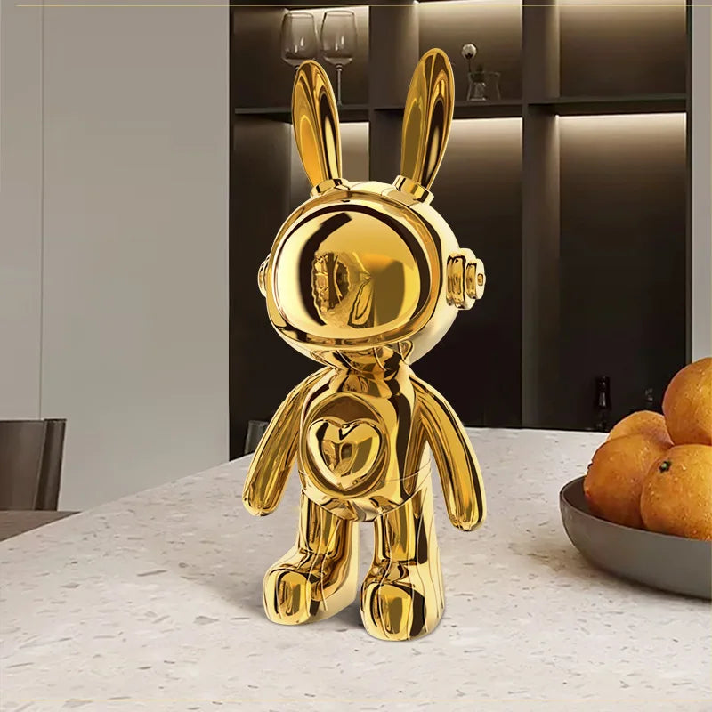 Gold rabbit-shaped decorative object on a table with a neutral background