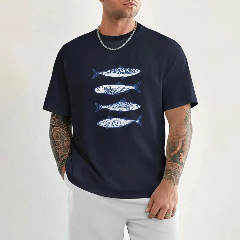Man wearing a navy blue t-shirt with fish designs on a white background