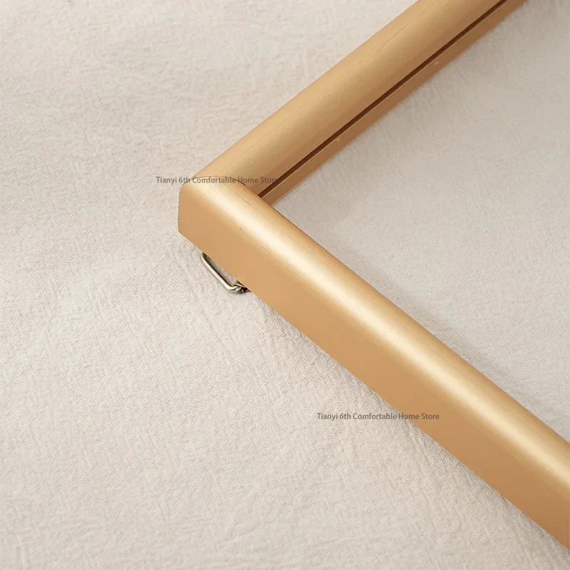 Gold picture frame on a textured beige wall