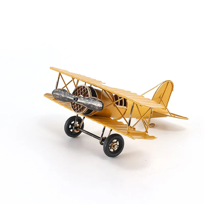 Vintage metal airplane ornament with a detailed retro aircraft design, available in red, yellow and blue for desk or shelf display.
