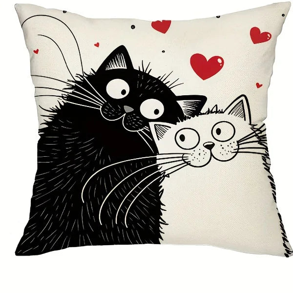 Decorative pillow with cartoon black cats and red hearts on a white background