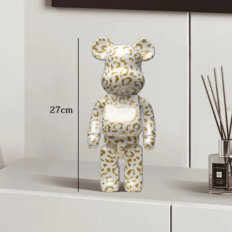 Leopard print bear figure on a white surface with a measurement label, next to a diffuser.