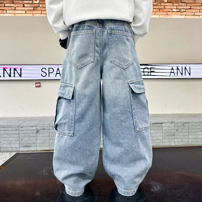 Person wearing light blue denim cargo pants with a blurred background