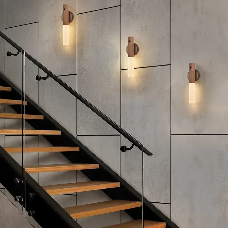 Rechargeable motion sensor LED night light shown lit up on a stairway