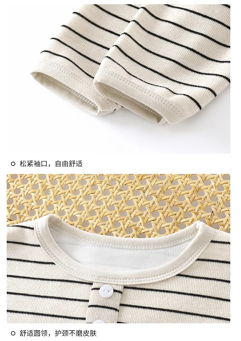 Close-up of a striped shirt with a button on a textured surface