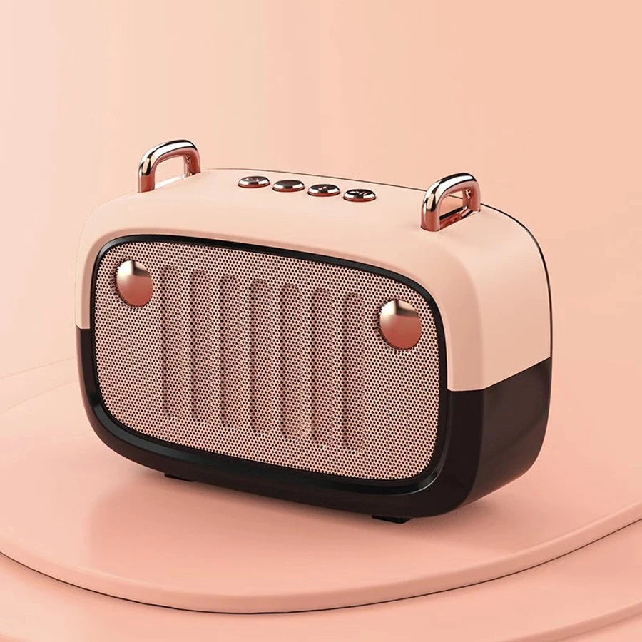Pink and rose gold portable speaker on a pink background