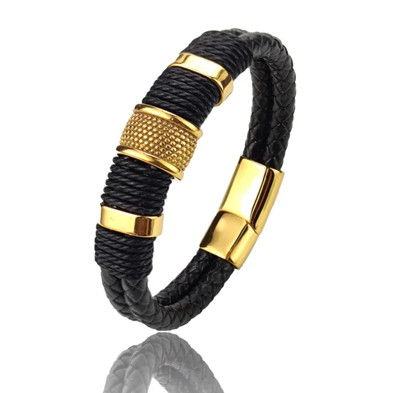 Black braided bracelet with gold cylindrical accents on a white background