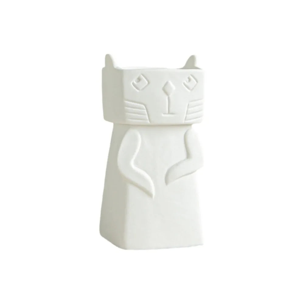 A white ceramic cat-shaped container or candle holder with a minimalist, geometric design, shown against a plain white background.