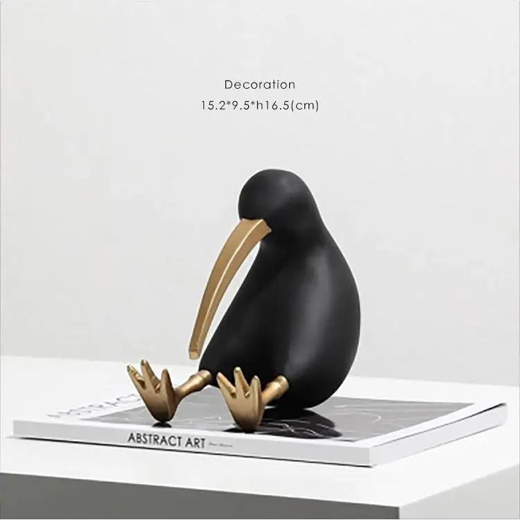 Black and gold bird figurine on a magazine with dimensions displayed