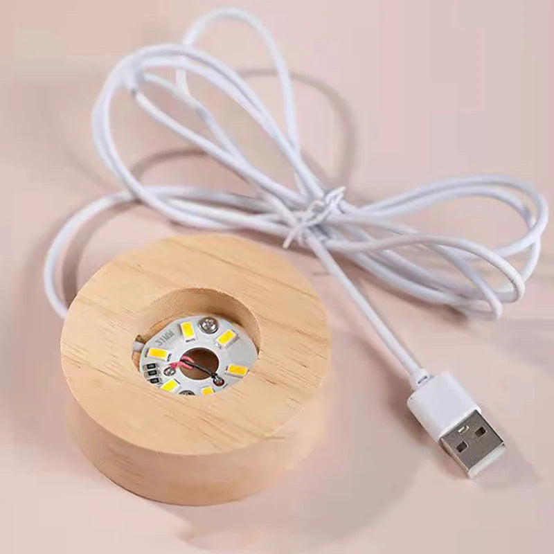 Wooden cylindrical light with USB cable on a beige background