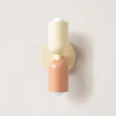 Two-toned wall sconce with beige and pink design on a light gray background