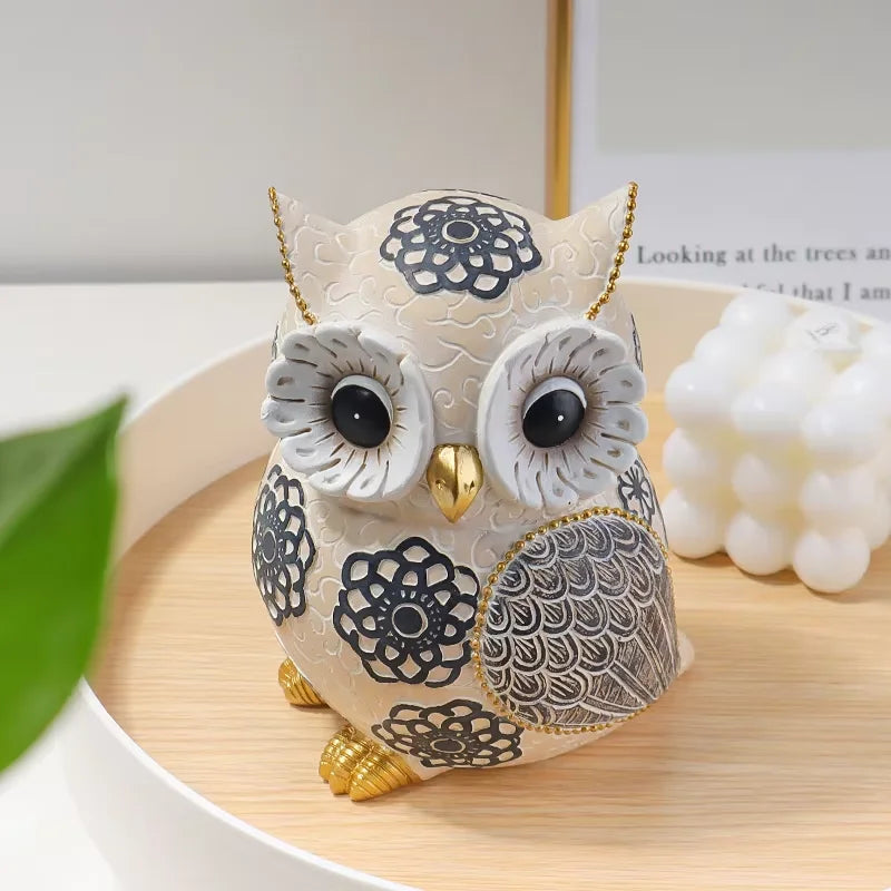 Decorative owl figurine with floral patterns on a wooden surface