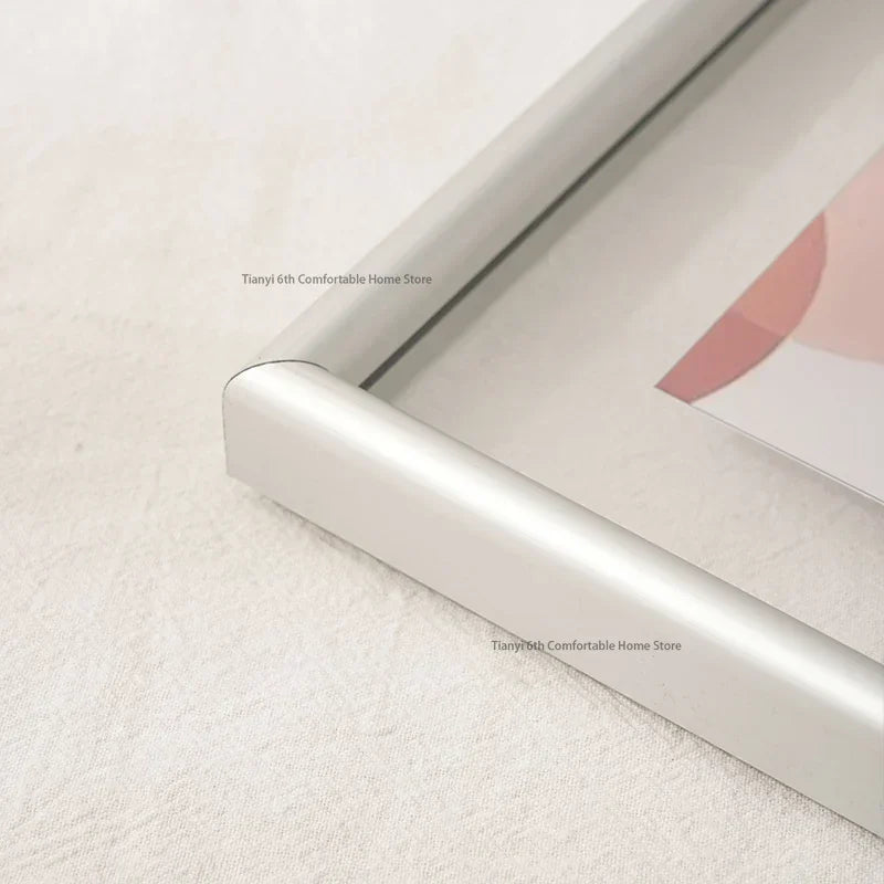 Silver picture frame corner on a white surface with 'Tianyi 6th Comfortable Home Store' branding.