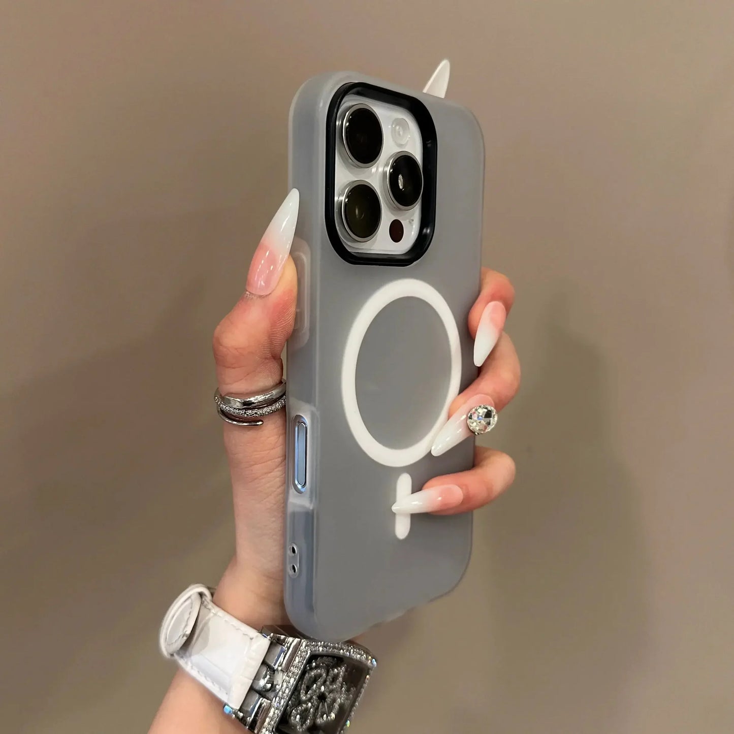 Hand holding a phone case with a unique design on a plain background