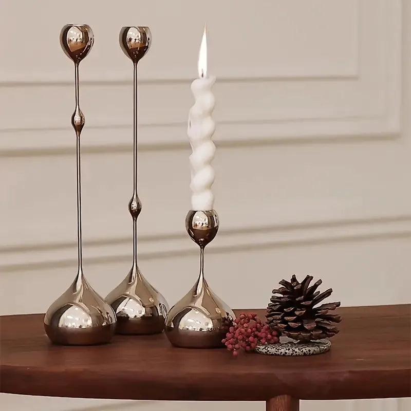 Decorative candle holders with a candle on a wooden surface