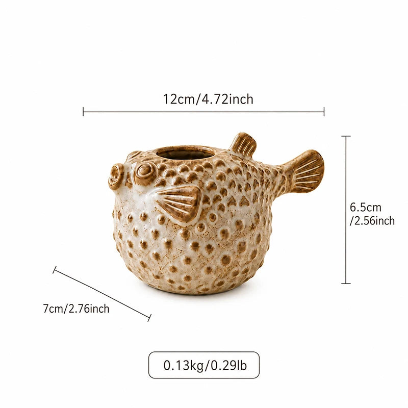 A puffer fish shaped ceramic planter in a textured beige and brown glaze, shown with dimension lines indicating its 12cm width, 6.5cm height, 7cm depth, and weight of 0.