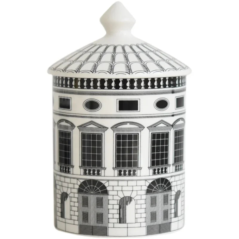 Decorative candle jar with architectural design on a white background