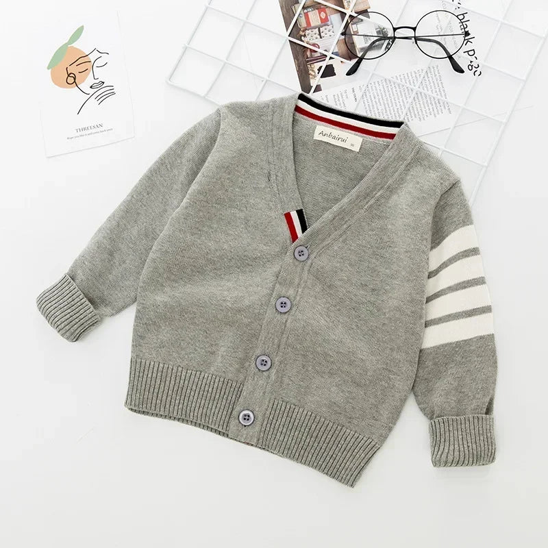 Gray cardigan with button details on a white background