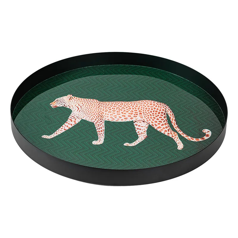 Round tray with a leopard design on a green background