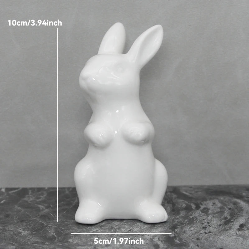 White ceramic rabbit figurine with measurements on a gray background