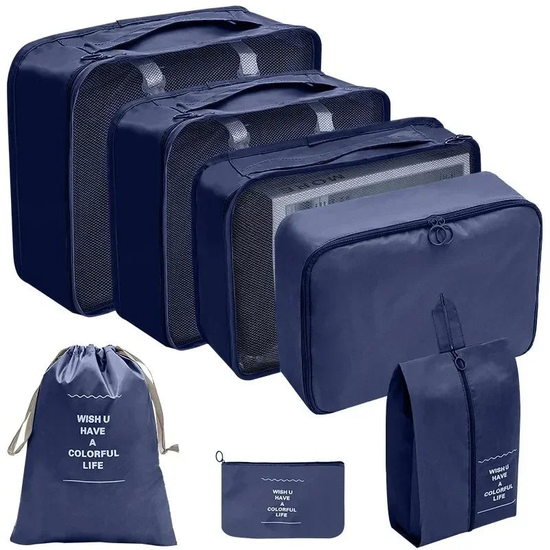 Set of navy blue packing cubes and bags with motivational text on a white background