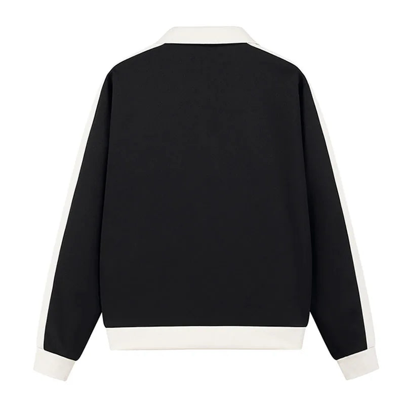 Black sweater with white trim on a white background