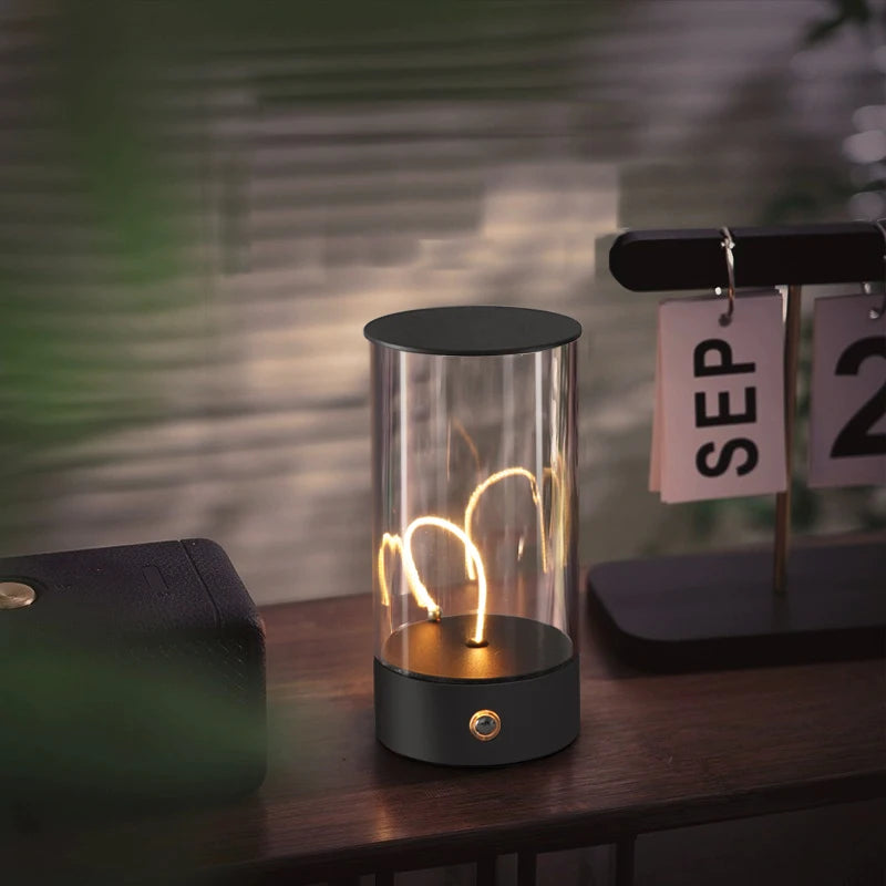 Table lamp with a visible light bulb inside a glass enclosure on a wooden surface.