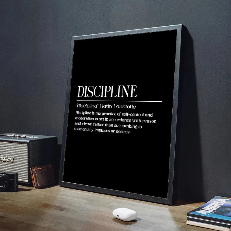 Framed poster with the word 'Discipline' and its definition on a dark surface.
