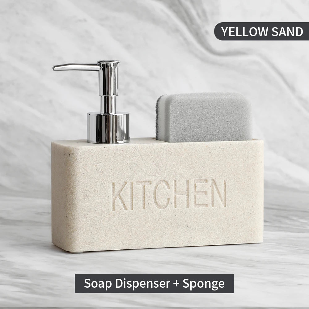 Soap dispenser and sponge set with 'KITCHEN' engraving on a marble surface.