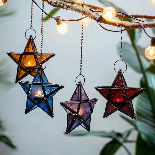 Star-shaped lanterns hanging from a branch with string lights against a natural background