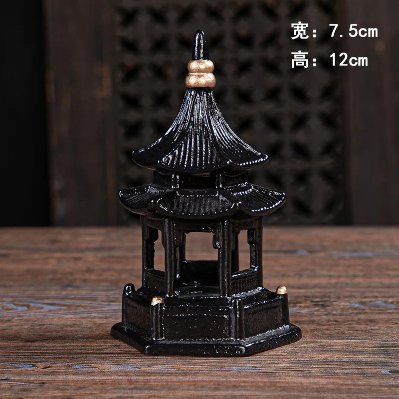 Small black pagoda model on a wooden surface with measurements displayed.