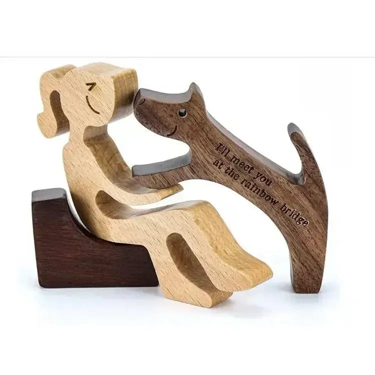 Wooden sculpture of a dog and a cat embracing with engraved text on a white background